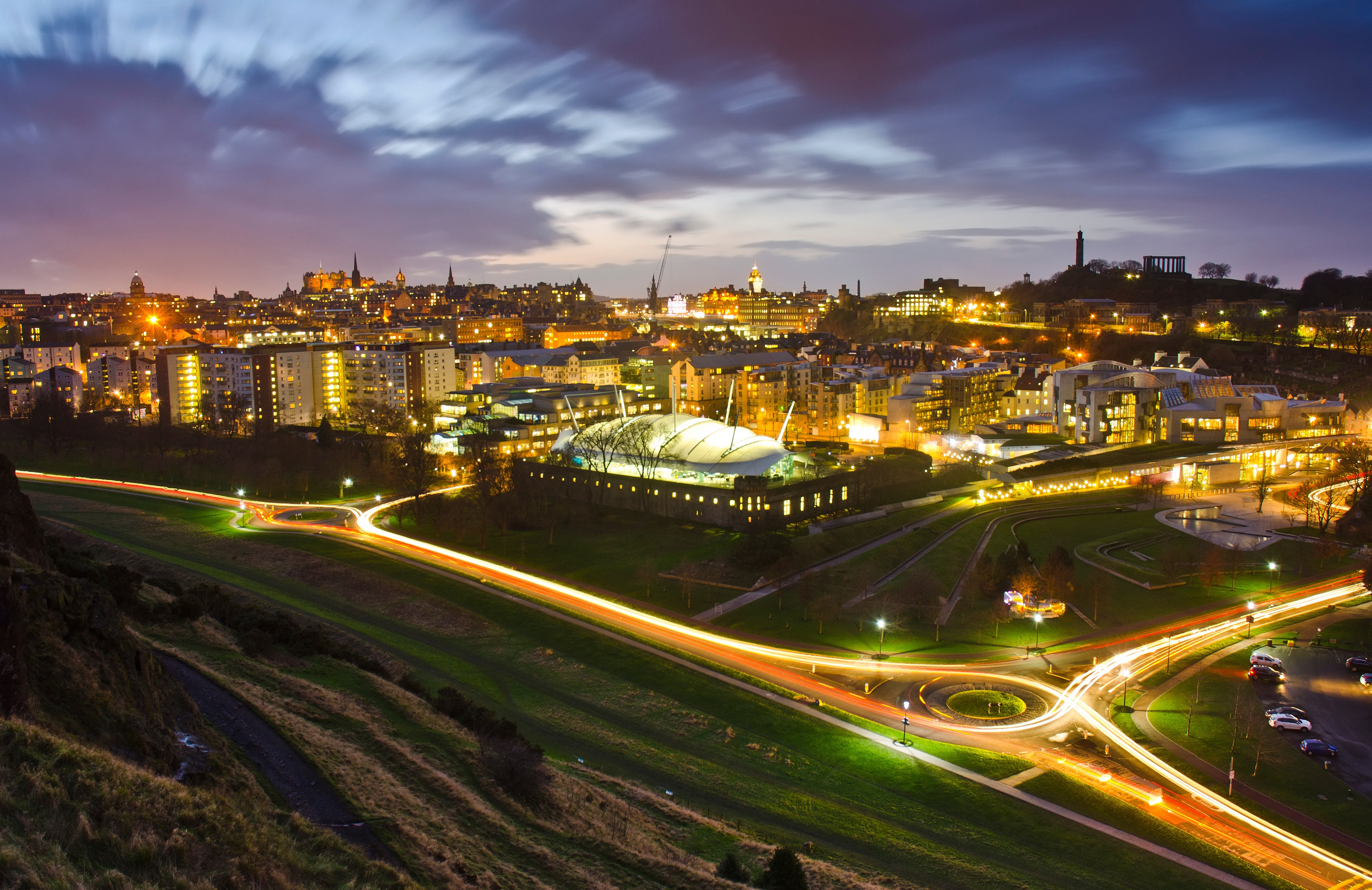 Long-exposure night view of Edinburgh showing traffic and movement through the city