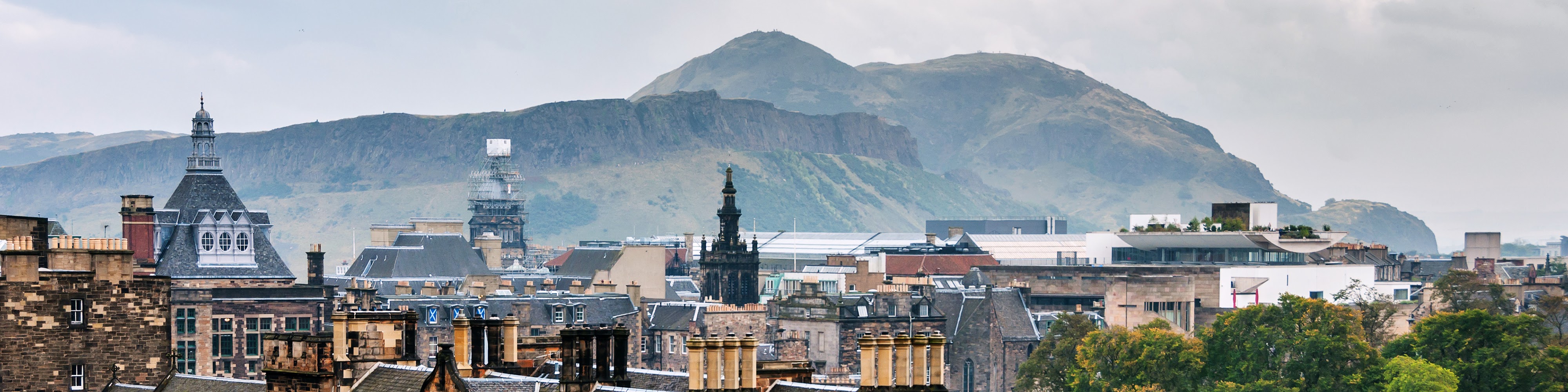 Panoramic view of Edinburgh with Arthur's Seat and Salisbury Crags rising behind the city